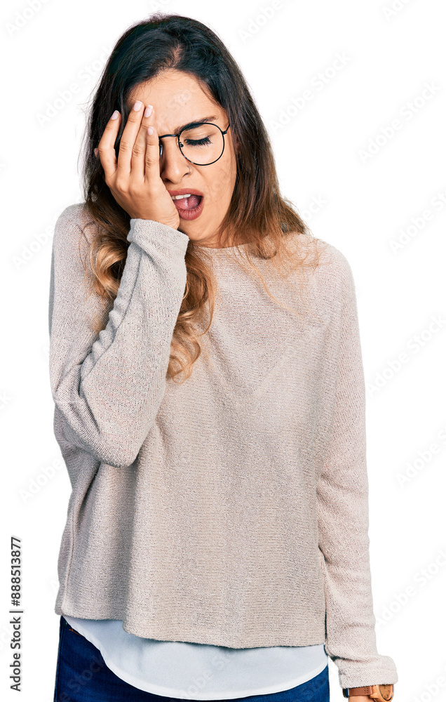 Beautiful hispanic woman wearing casual sweater and glasses yawning tired covering half face, eye and mouth with hand. face hurts in pain. Beautiful hispanic woman wearing casual sweater and glasses yawning tired covering half face, eye and mouth with hand. face hurts in pain.
