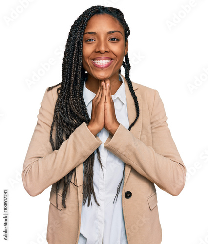 African american woman wearing business jacket praying with hands together asking for forgiveness smiling confident. photo