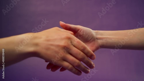 Beautiful female hand on isolated on purple background two hands handshake sign language