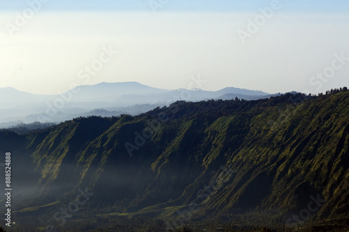 Misty valley at north-east of Mount Bromo in East Java, Indonesia photo