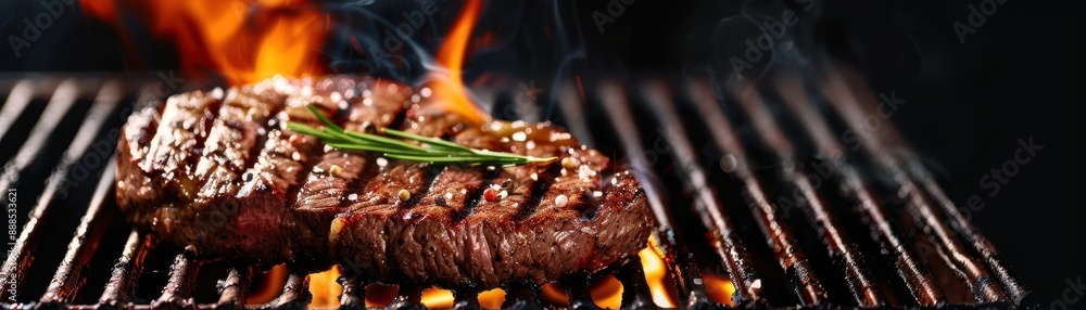 Juicy grilled steak with rosemary on a flaming barbecue grill. Perfect for food, cooking, and gastronomy-related projects. Juicy grilled steak with rosemary on a flaming barbecue grill. Perfect for food, cooking, and gastronomy-related projects.