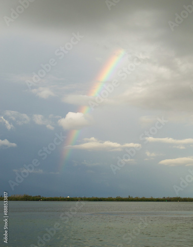 Fotografie Rainbow arching over the water on the Gulf of Mexico