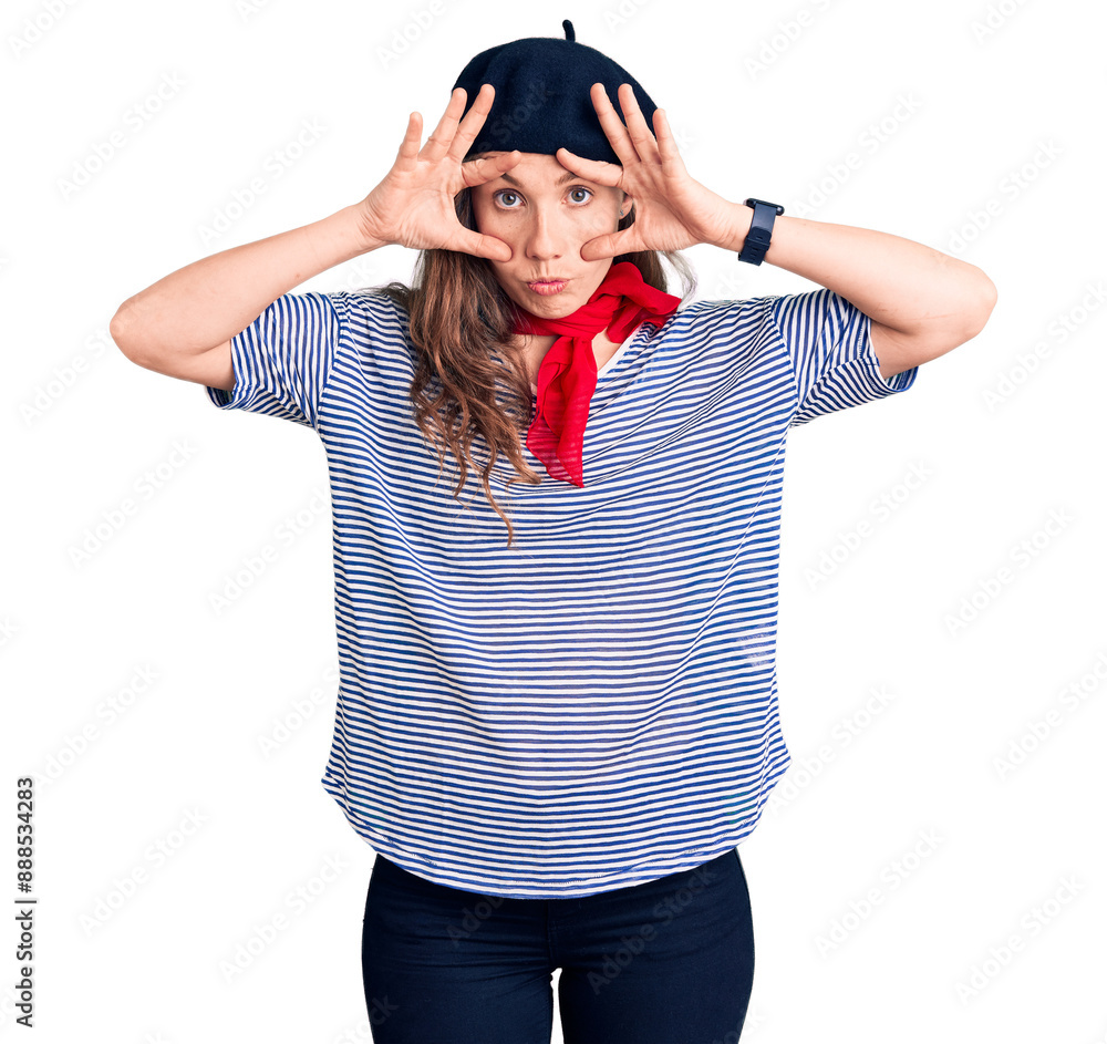 Young beautiful blonde woman wearing french beret and striped t-shirt trying to open eyes with fingers, sleepy and tired for morning fatigue Young beautiful blonde woman wearing french beret and striped t-shirt trying to open eyes with fingers, sleepy and tired for morning fatigue