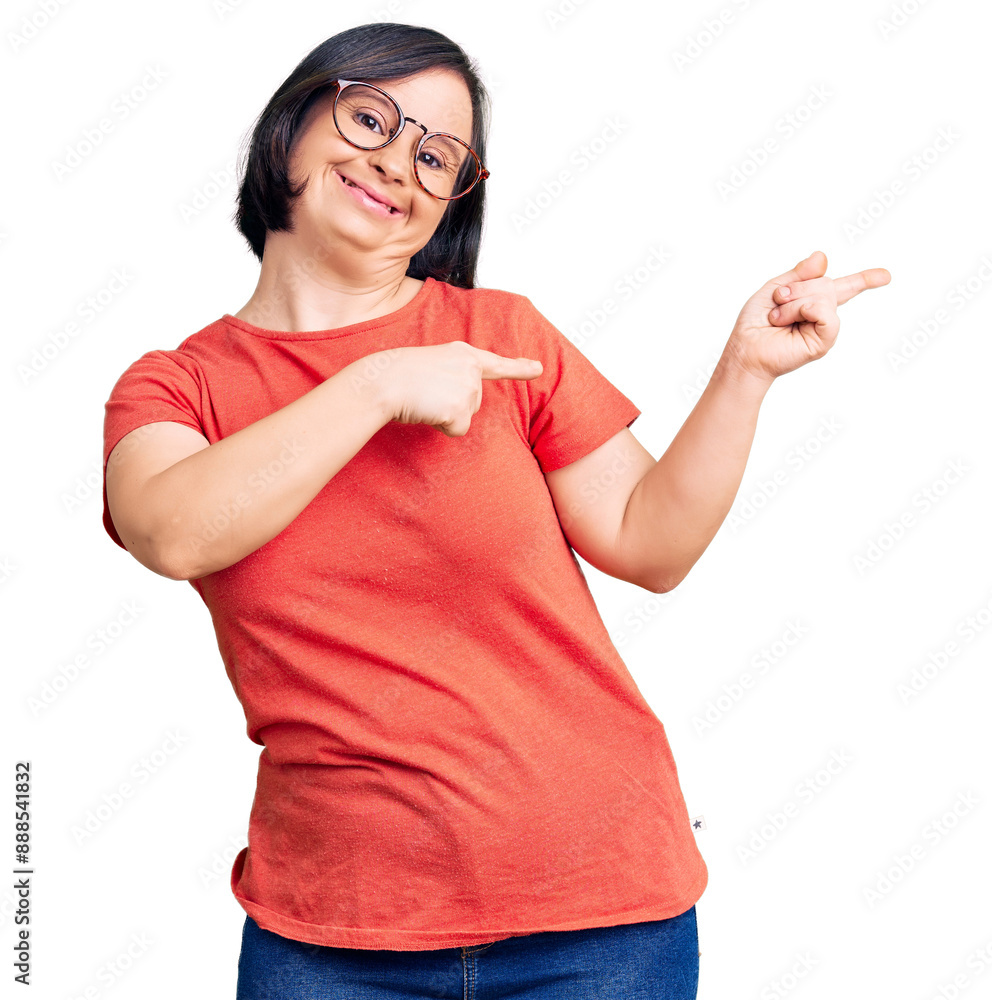 Brunette woman with down syndrome wearing casual clothes and glasses smiling and looking at the camera pointing with two hands and fingers to the side. Brunette woman with down syndrome wearing casual clothes and glasses smiling and looking at the camera pointing with two hands and fingers to the side.