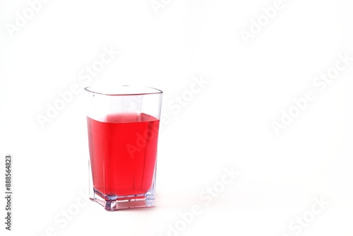 red drink on transparent glass