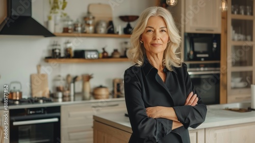 Stylish and confident middle-aged woman standing at the kitchen in her modern home. mature business woman Blonde executive business manager
