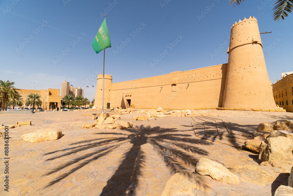 Riyadh, Saudi Arabia: Saudi national flag flies above the famous Masmak fort in Riyadh old town in Saudi Arabia capital city on a sunny day.
