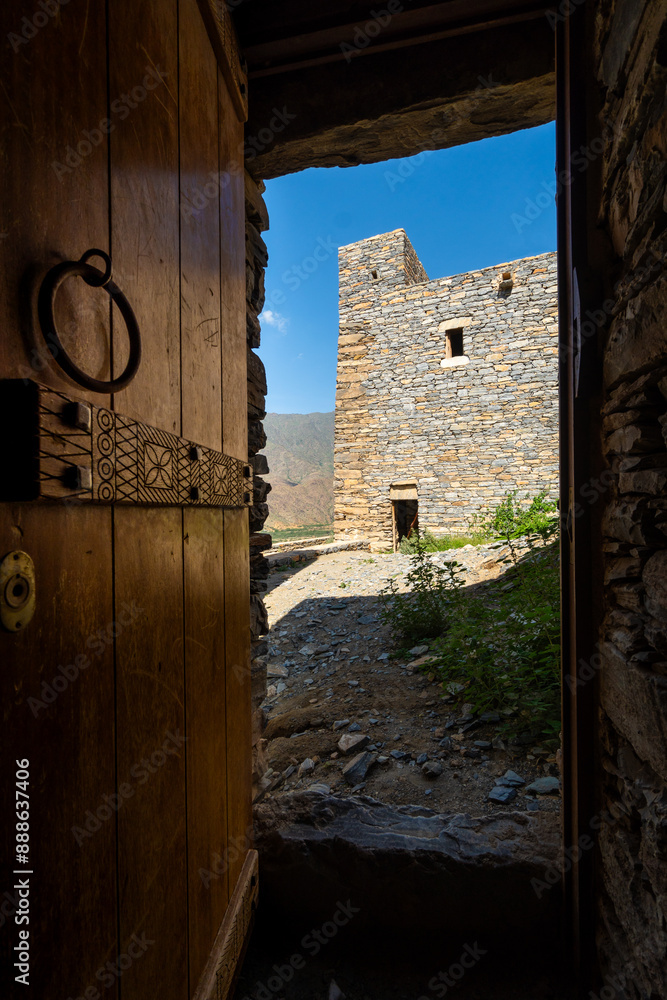 Al Bahah, Saudi Arabia: A view through an old wooden door of the Thee Ain, or Zee Ain ancient village in Saudi Arabia near Jeddah.