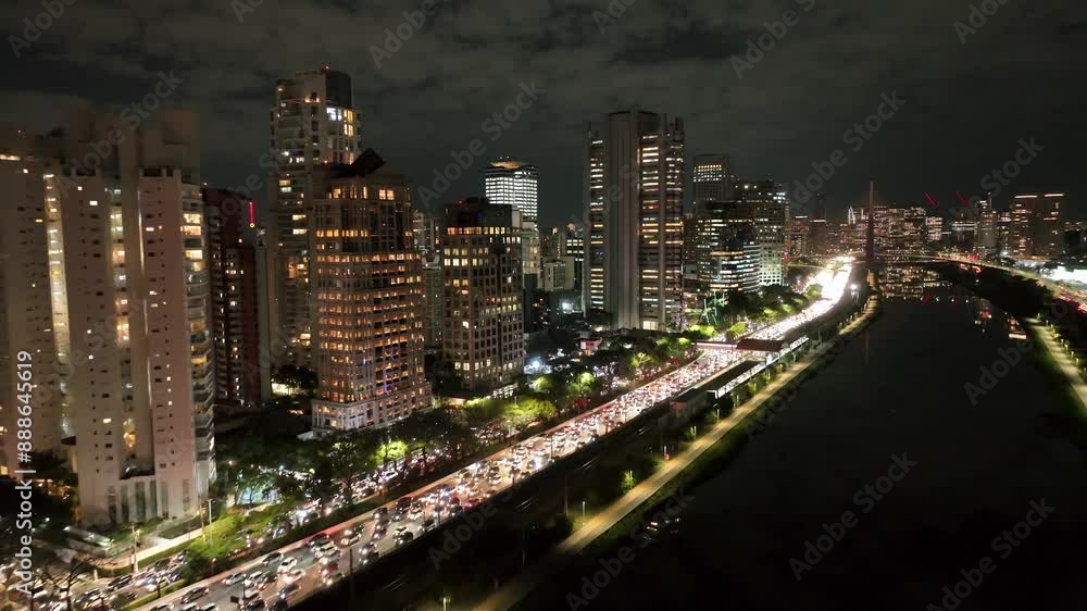 Illuminated Buildings At Night City Sao Paulo Brazil. Bird Eye View Of Famous Building In Vibrant District Of City. Night Highway Road Downtown Cityscape. Night Exterior Panorama. Illuminated Buildings At Night City Sao Paulo Brazil. Bird Eye View Of Famous Building In Vibrant District Of City. Night Highway Road Downtown Cityscape. Night Exterior Panorama.