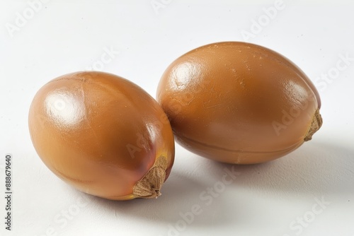 Pair of argan fruits on white background