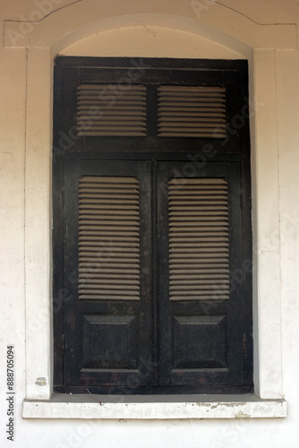 An old wooden window with vintage design. The concept of an old historic building in Cepu, Central Java. photo