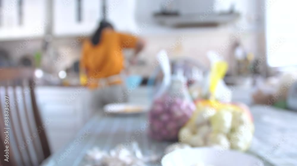 Blur woman cooking a food in the kitchen Blur woman cooking a food in the kitchen