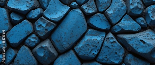 Blue rocks and stones arranged in a textured pattern, offering a rugged and natural background ideal for construction, design, or geological themes photo