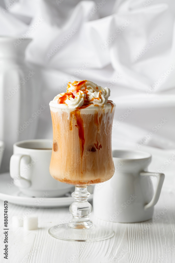 Iced caramel latte topped with whipped cream and caramel sauce. Iced caramel latte topped with whipped cream and caramel sauce.