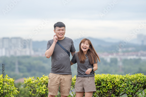 Photography Chinese Malaysian man and woman sitting close together in a small hill park in Kuala Lumpur, Malaysia