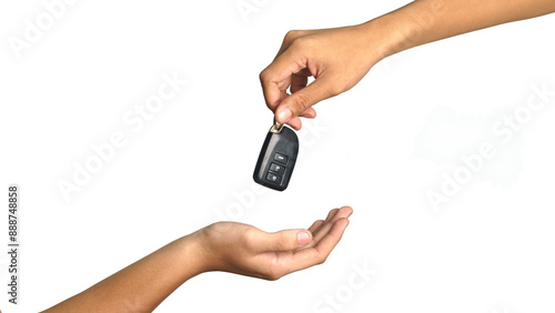 Tablou pe pânză Male hand holding a car key and handing it over to another person isolated