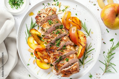 Pork tenderloin with quince apples on white plate top view