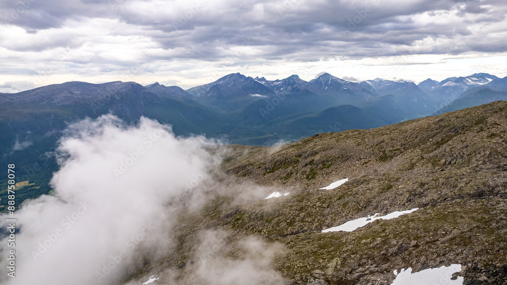 drone aerial view over Andalsnes and Romsdalseggen mountains in summer with sunset and fog in Norway Romsdalen and Romsdalseggen Ridge drone aerial view over Andalsnes and Romsdalseggen mountains in summer with sunset and fog in Norway Romsdalen and Romsdalseggen Ridge