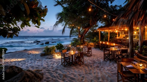 Fototapeta Naklejka Na Ścianę i Meble -  A beachside restaurant with tables and chairs set up on the sand
