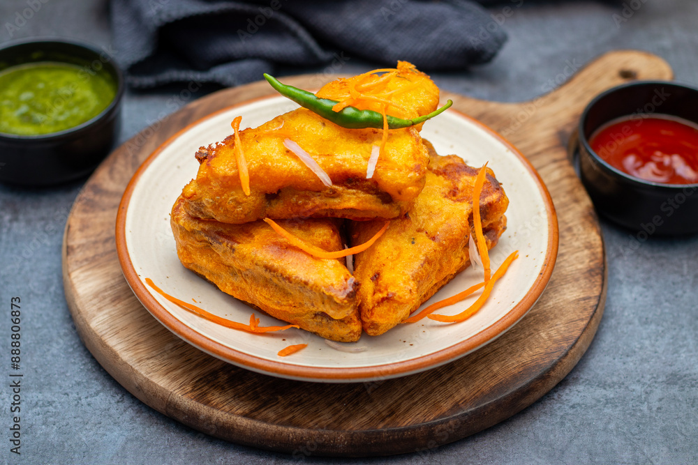 Selective Focus of Bread pakora is a popular Indian street food made with bread, stuffed with spicy potato filling, coated in chickpea flour, and deep-fried. Selective Focus of Bread pakora is a popular Indian street food made with bread, stuffed with spicy potato filling, coated in chickpea flour, and deep-fried.