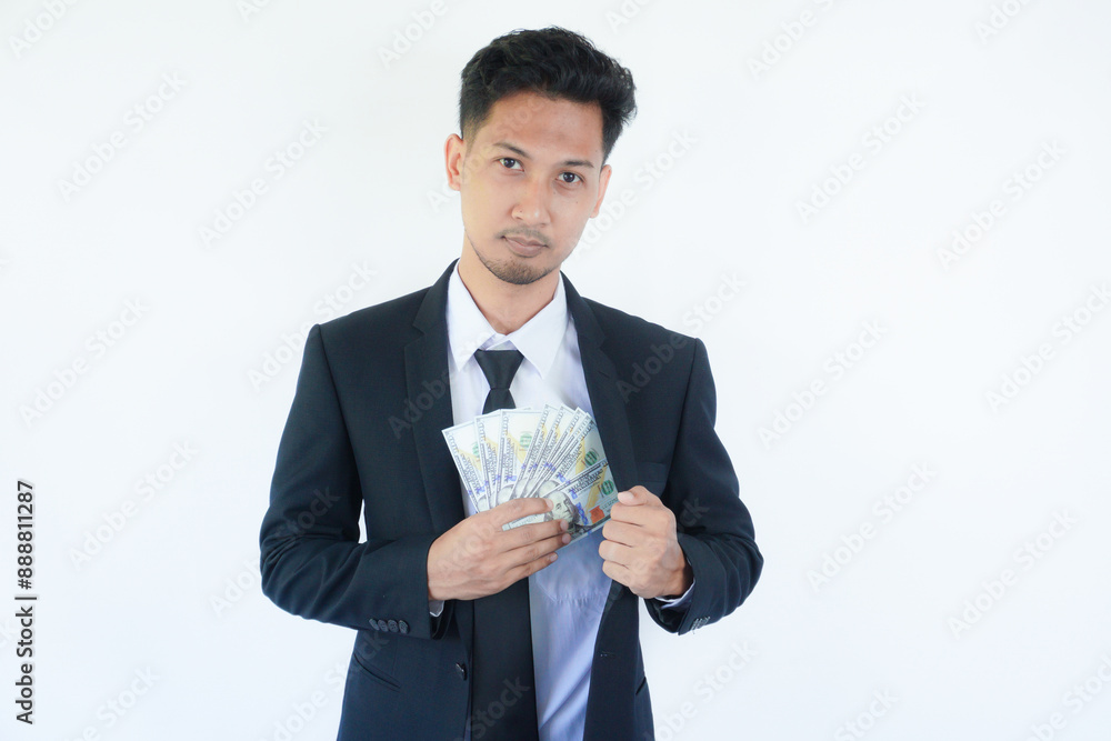 Man putting bribe money into pocket on white background, Concept for corruption, finance profit, bail and crime Man putting bribe money into pocket on white background, Concept for corruption, finance profit, bail and crime