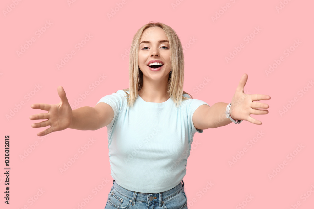 Beautiful young woman opening arms for hug on pink background Beautiful young woman opening arms for hug on pink background