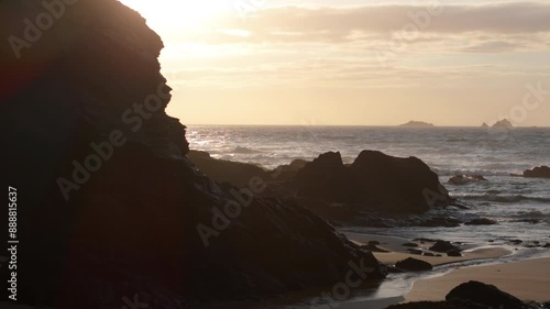 Treyarnon beach scenic sunset view over ocean with The Quies islands on horizon photo