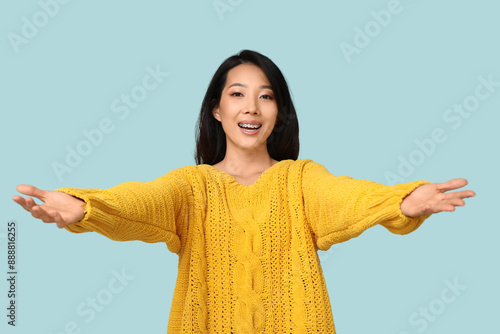 Young Asian woman opening a...