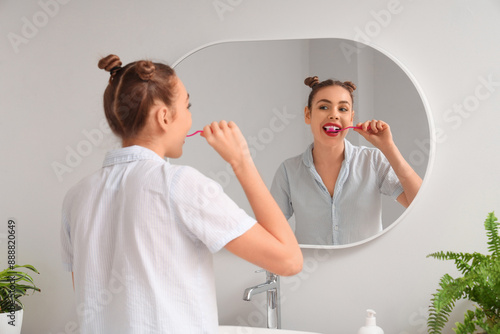 Beautiful young woman brush...