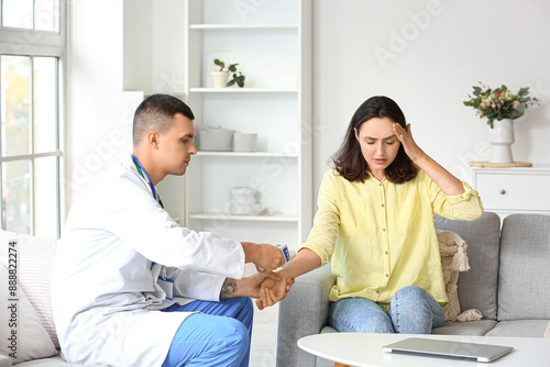 Male doctor measuring young...