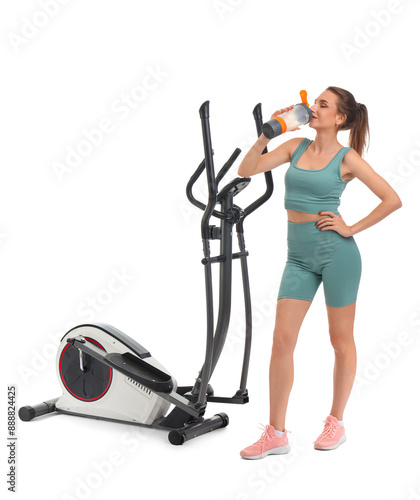 Sporty young woman drinking...