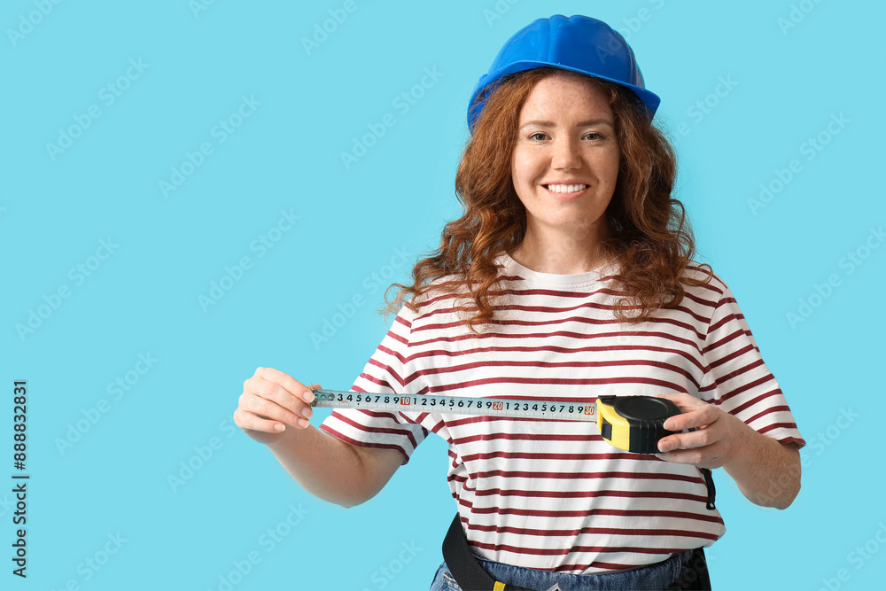 Female construction worker with measuring tape on blue background Female construction worker with measuring tape on blue background