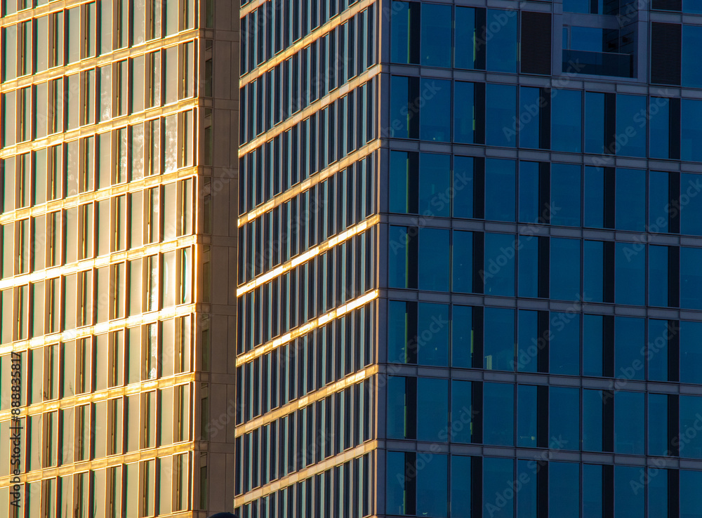 The sun's rays illuminate part of a modern building during the golden hour. The sun's rays illuminate part of a modern building during the golden hour.