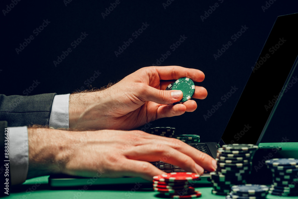 Person Playing Online Poker Game With Laptop and Chips Person Playing Online Poker Game With Laptop and Chips