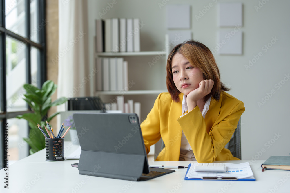 Asian businesswoman is tired, sleepy, has a headache, stressed from work and bored from sitting at a desk for a long time and has office syndrome. Asian businesswoman is tired, sleepy, has a headache, stressed from work and bored from sitting at a desk for a long time and has office syndrome.
