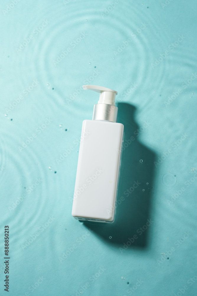Cosmetic bottle in the water with waves. Top view. Cosmetic bottle in the water with waves. Top view.