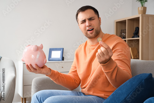 Bankrupt young man with pig...