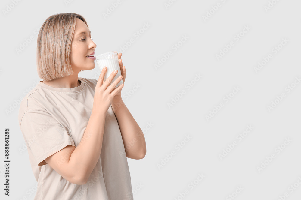 Beautiful young woman drinking fresh milk on white background Beautiful young woman drinking fresh milk on white background