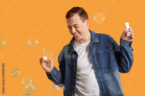 Young happy man playing wit...