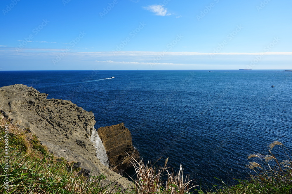 rock coast and far island rock coast and far island