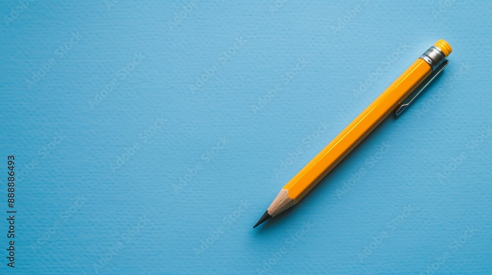Yellow pencil on blue background Yellow pencil on blue background