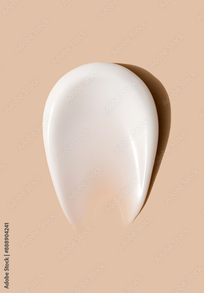 creamy smear of white cosmetic texture close up on beige background skin care concept creamy smear of white cosmetic texture close up on beige background skin care concept