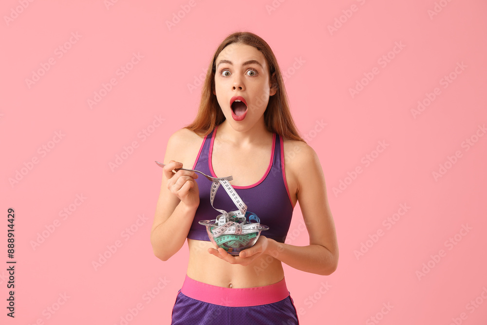 Surprised young woman with measuring tape in bowl on pink background. Diet concept Surprised young woman with measuring tape in bowl on pink background. Diet concept