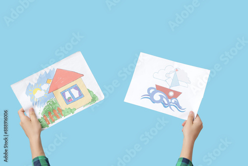 Child with drawings on blue...