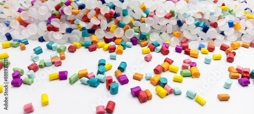 Colorful masterbatch granules isolated on a white background for industrial plastic product catalog banner design