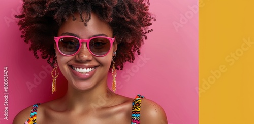 Smiling Woman Wearing Colorful Sunglasses and Earrings Against Pink Background