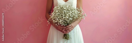Bride Holding White Babys Breath Bouquet Against Pink Wall