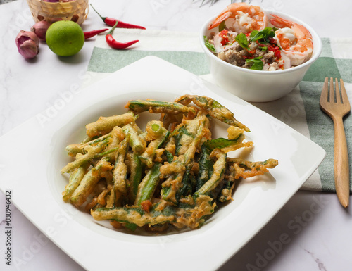 Deep fried morning glory with spicy salad - Thai food called Yum Puk Boong Krob at close up view