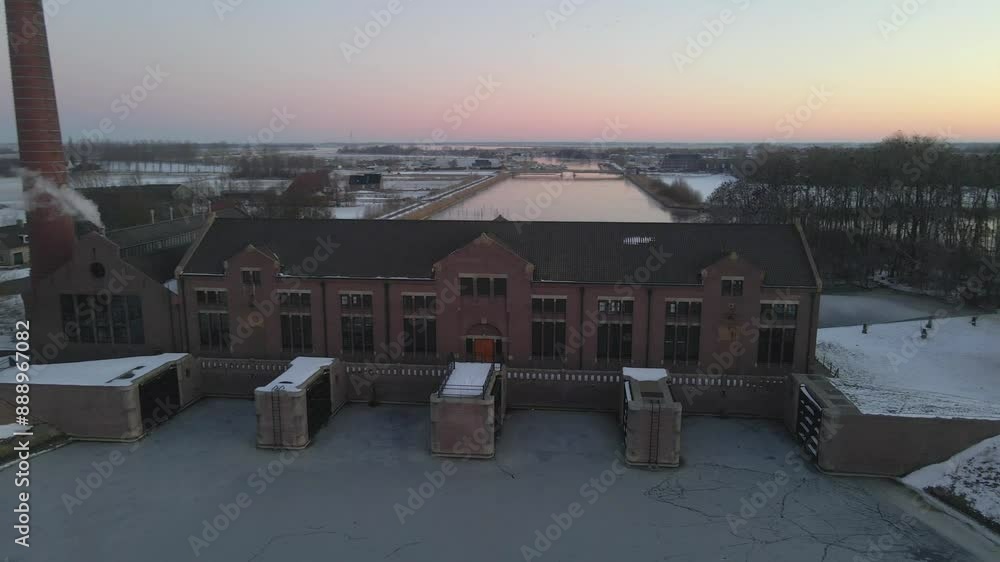 Aerial view of snow-covered UNESCO pumping station and frozen canal, Lemmer, Friesland, Netherlands. Aerial view of snow-covered UNESCO pumping station and frozen canal, Lemmer, Friesland, Netherlands.