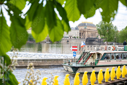 Obraz na płótnie Prague, Czech Republic. Pleasure boat on the river in Prague. Chestnut leaves in the foreground, selective focus. w salonie